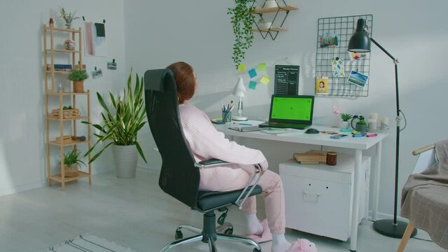 Lazy female designer twists and turns in her chair