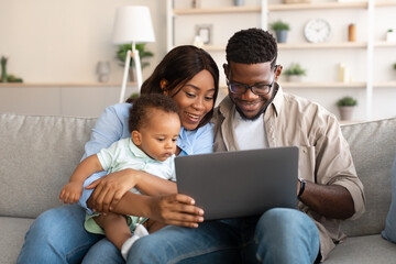 Fototapeta premium Portrait of black family using tablet at home