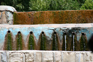 Fototapeta premium Pour water from the waterway in the garden
