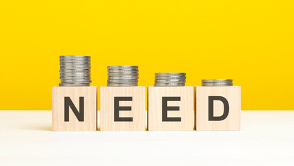 text need on wooden cubes on yellow background