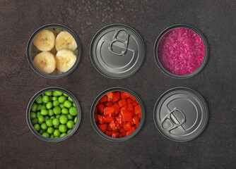 The concept of food in metal containers, canned food, dark background ...
