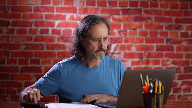 Funny Portrait Of Frustrated Man Doing Taxes And Yelling Screaming At Camera. Concept Of Anger During Tax Prep Season.