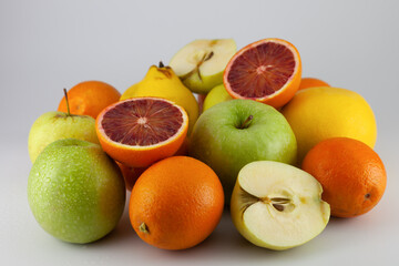 various fruits on a white background. Apple, orange, quince, grapefruit