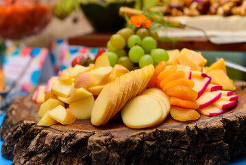 tray with cheeses, apricots and grapes, cold dish, cold platter,accompaniment to wine, snack to wine