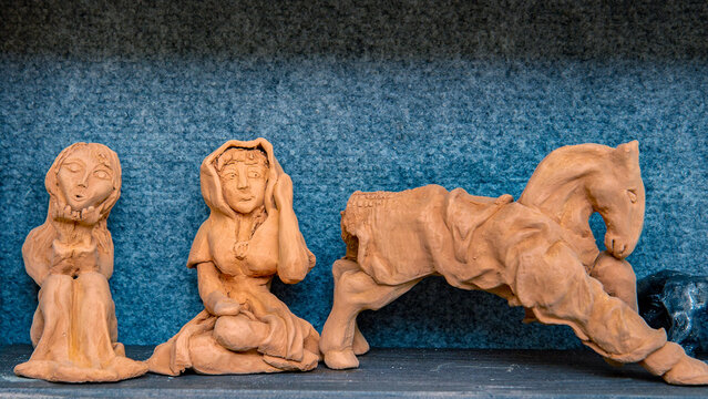 clay figurines. folk pottery artisan workshop. girls, horse