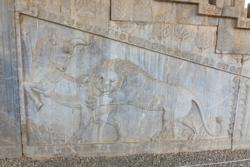 Lion attacking a bull in the ancient Persepolis, Iran