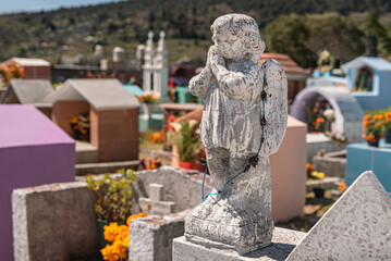 Little angels on top of graces in the Day of the Dead in Mexico