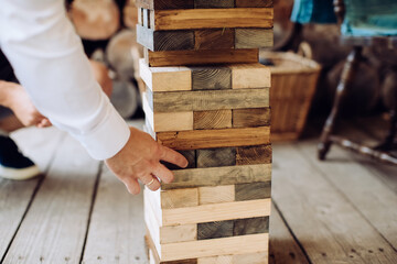 Friends playing jenga game at the party