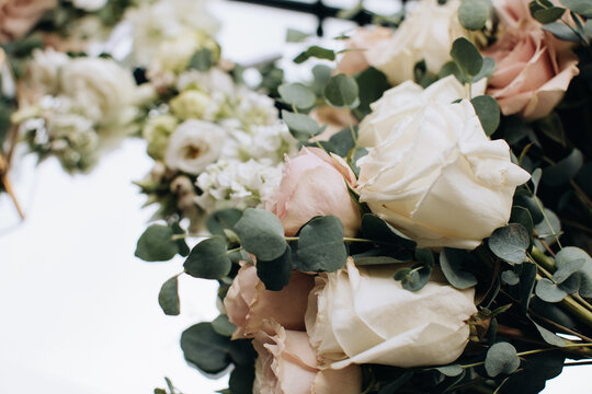 Beautiful wedding bouquets of beige roses for the bride. Wedding accessories