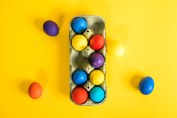 Multi-colored Easter eggs in an egg tray