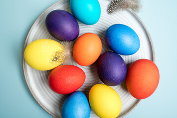 Fototapeta na wymiar Coloured decorated easter eggs on a blue background