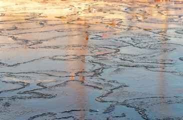 melting ice on the surface of the lake