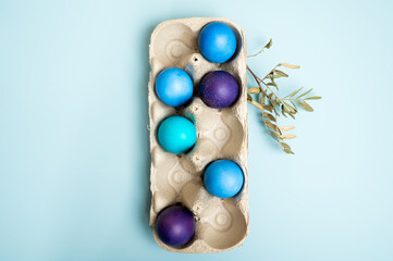 Multi-colored Easter eggs in an egg tray