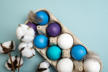 Multi-colored Easter eggs in an egg tray