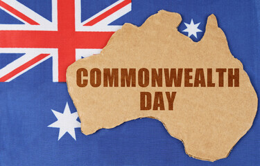 On the flag of Australia lies the contour of the map of the country with the inscription -...