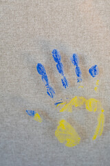 child's hand painted in the colors blue and yellow