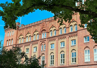 Fototapeta na wymiar Old red brick house in the city in summer. High quality photo