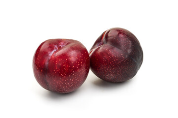 Red plums, isolated on white background.
