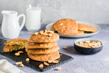 A stack of ready-to-eat fresh peanut cookies on a slate on a table. Homemade pastries. Copy space