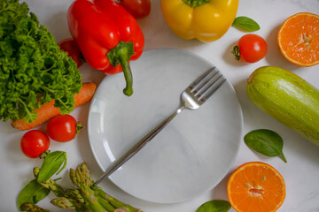 Fresh different vegetables, empty plate