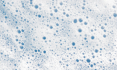 White soap foam surface or shower gel shampoo with bubbles. Abstract cosmetic blue background...