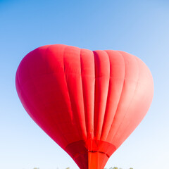 hot air balloon floating in the sky big red hot air balloon in the shape of a big heart for love and world peace