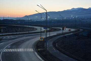 Almaty city highway night view with mountains in the morning