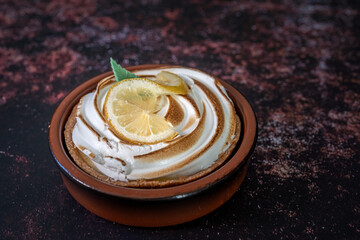 Traditional french lemon tart on a dark rusty table. close-up shot. View from above . copy space for text