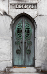 Ancient corroding metal doors to a mausoleum labeled Teideman in Bonaventure Cemetery, Savannah, Georgia, USA