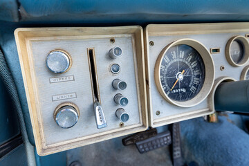 Close-up of vintage car dashboard and controls in a blue Chrysler Plymouth Valiant second...