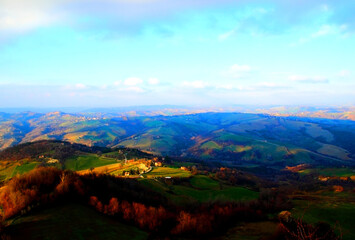 Spectacular view from above at Marchegian hills partly illuminated by sun and partly shaded by clouds in Penna San Giovanni