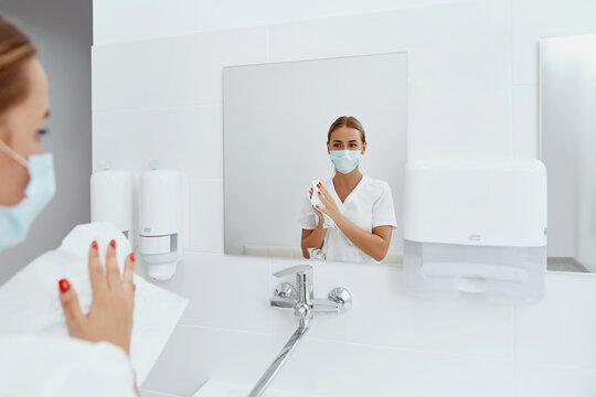 Hygiene, Health Care. Woman Doctor Or Nurse Drying Hands With Paper Tissue At Hospital After Washing Hands