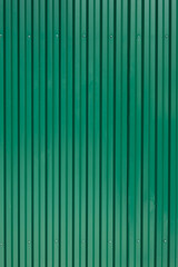 green metal fencing with vertical stripes