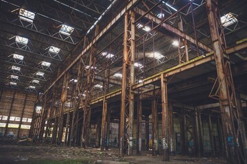 The sun's rays break through the roof of an abandoned warehouse 