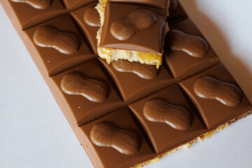 closeup of milk chocolate bar with nuts and salt caramel