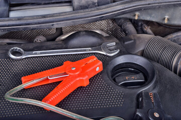 The ring spanner and electricity jumper cables to charging car battery