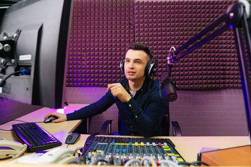 a radio host conducts a live broadcast in a professional radio studio. 