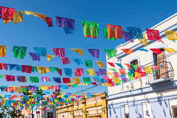 Festive colorful banners over a street in Todos Santos.