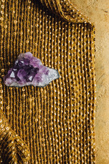 purple amethyst crystal geode rock on gold sequin fabric