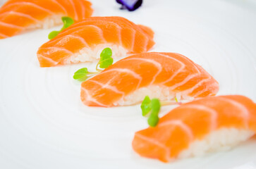 Naklejka na ściany i meble Delicious premium salmon nigiri on white handmade plate