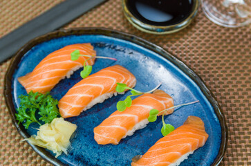 Delicious premium salmon nigiri on blue plate