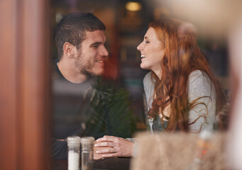 Could it be love. Shot of a loving young couple on a coffee date.