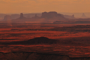 Hazy mid-afternoon view of the distant buttes and mesas of Monument Valley from Muley Point...