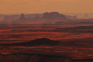 Hazy mid-afternoon view of the distant buttes and mesas of Monument Valley from Muley Point viewpoint, Utah, Southwest USA