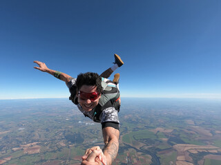 Relaxed and happy skydiver man on a summer day.