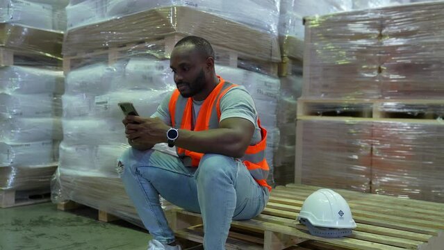 Business concept of 4k Resolution. Employees are taking a break from working in a warehouse. playing mobile phone.