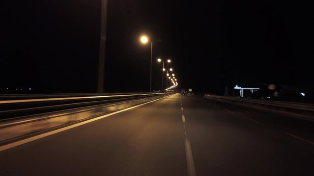 POV in the car, driving on a dark empty road, highway  in the middle of the night