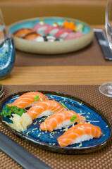 Delicious premium salmon nigiri on blue plate