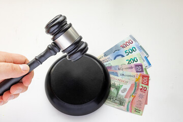 Wood Gavel and Sound Block and Mexican Banknotes. Concept: Justice Corruption