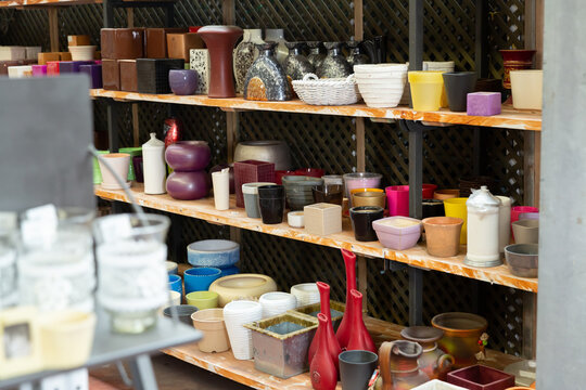 Variety of clay and plastic flowerpots and cachepots for houseplants on sale in store